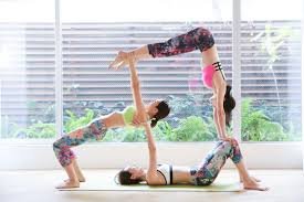 girls doing acro-yoga