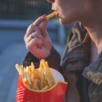 Overeating often includes having a lot of calorie-dense, non-healthy foods while disregarding essential nutrients.